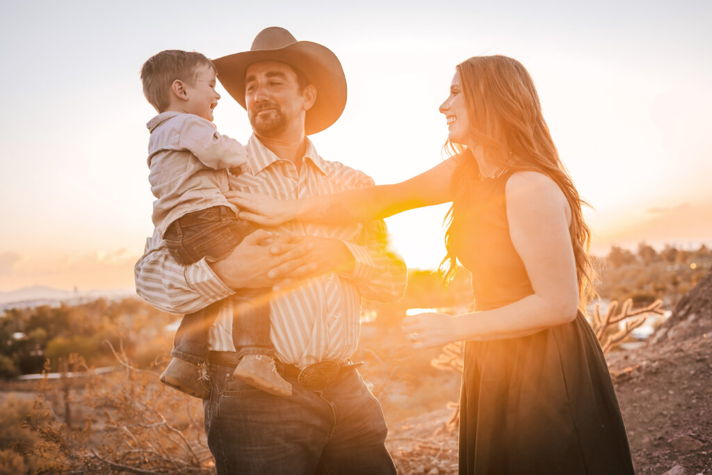 Phoenix photographer captures family in golden hour sun with candid storytelling moment at Papago Park.