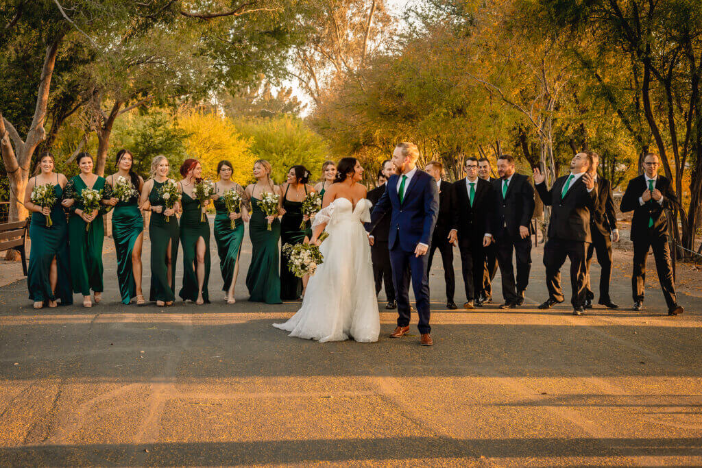 photo of bride and groom walking in front of their wedding party