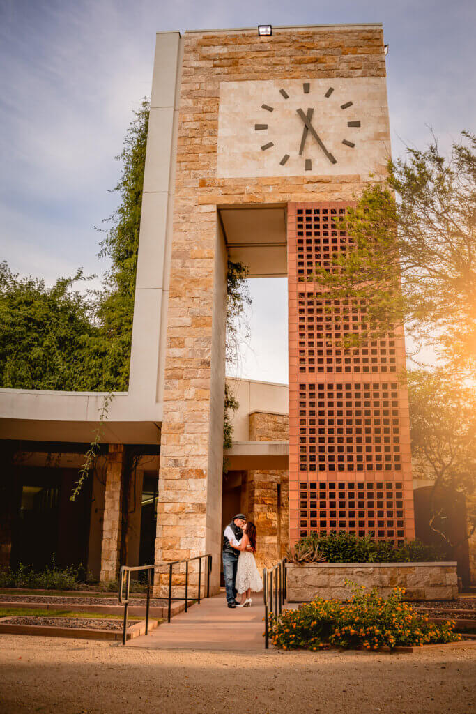 photo of couple kissing under a clock tower in surprise civic center in surprise az