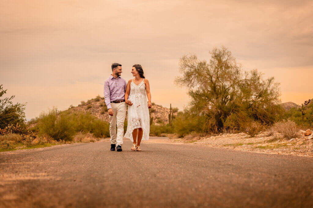 photo of elopement couple holding hands in the desert walking