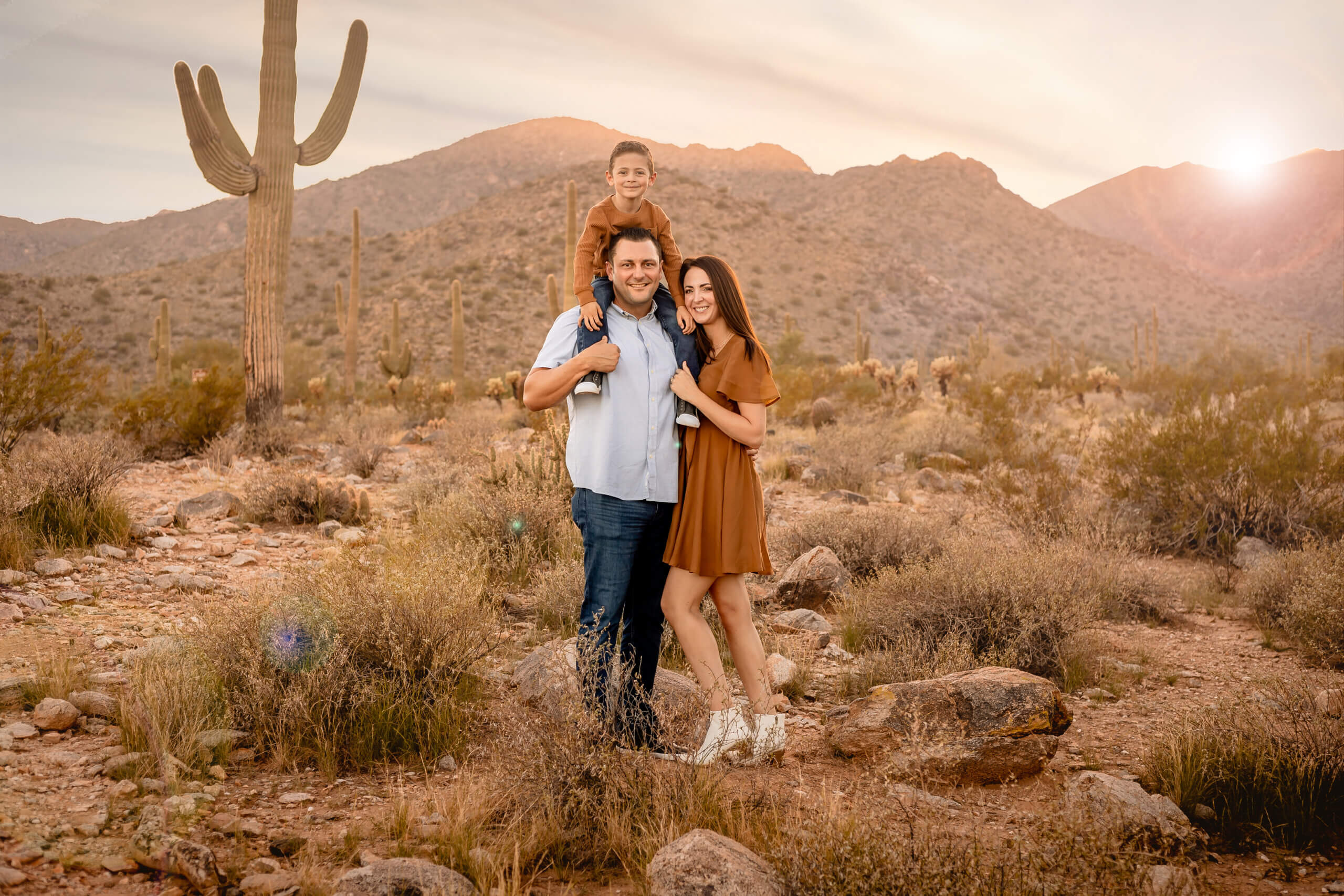 photo of family during Arizona sunset, boy on dad's shoulders in phoenix arizona area at the White Tank Mountains in AZ