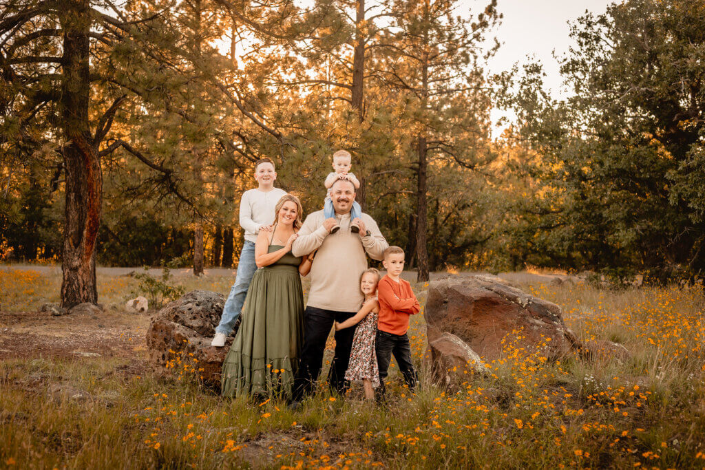 photo of family posed in wildflower field at Buffalo Park in Flagstaff, Arizona