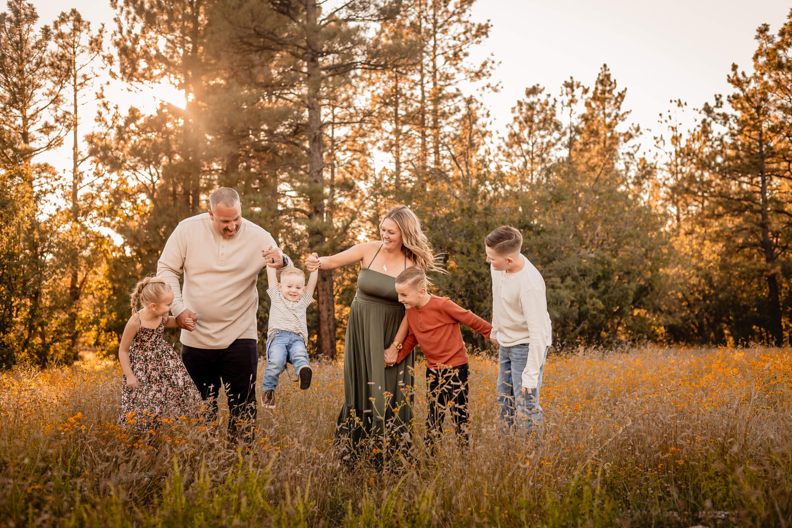 photo of family interacting in green flagstaff wildflower field