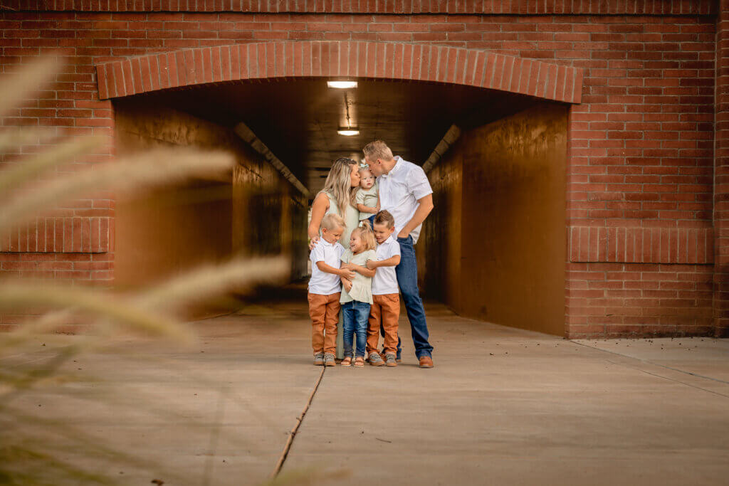 photo of family in front of brick wall and tunnel in Marley Park, in Surprise, Arizona