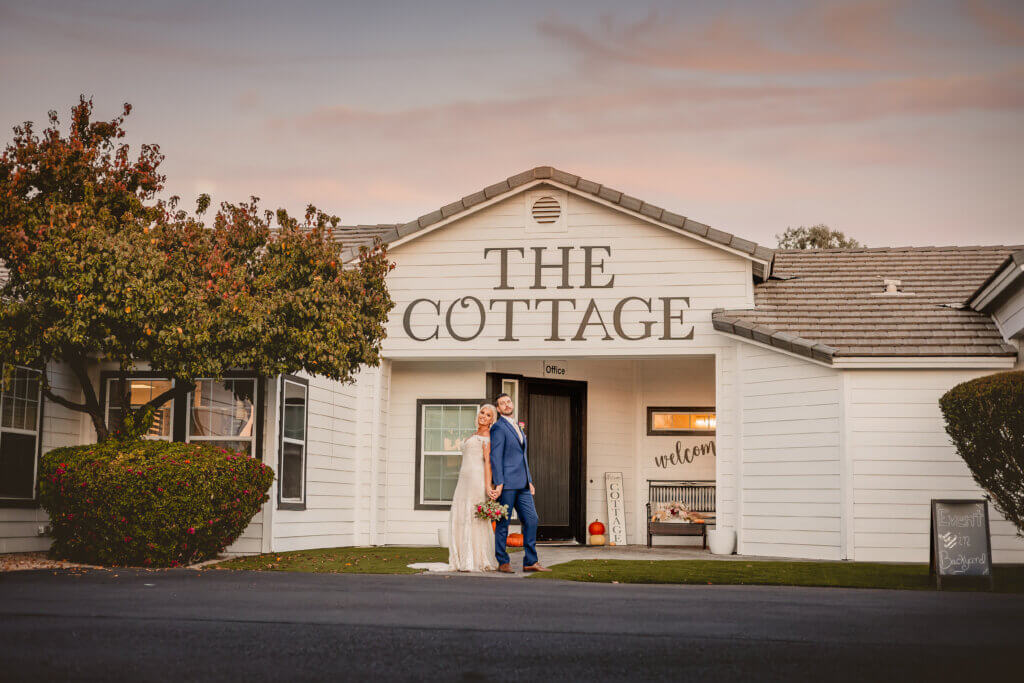 photo of wedding couple standing in front of the cottage wedding venue in Gilbert, Arizona