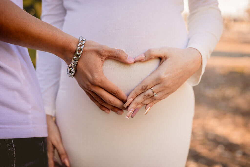 photo of hands on pregnant belly