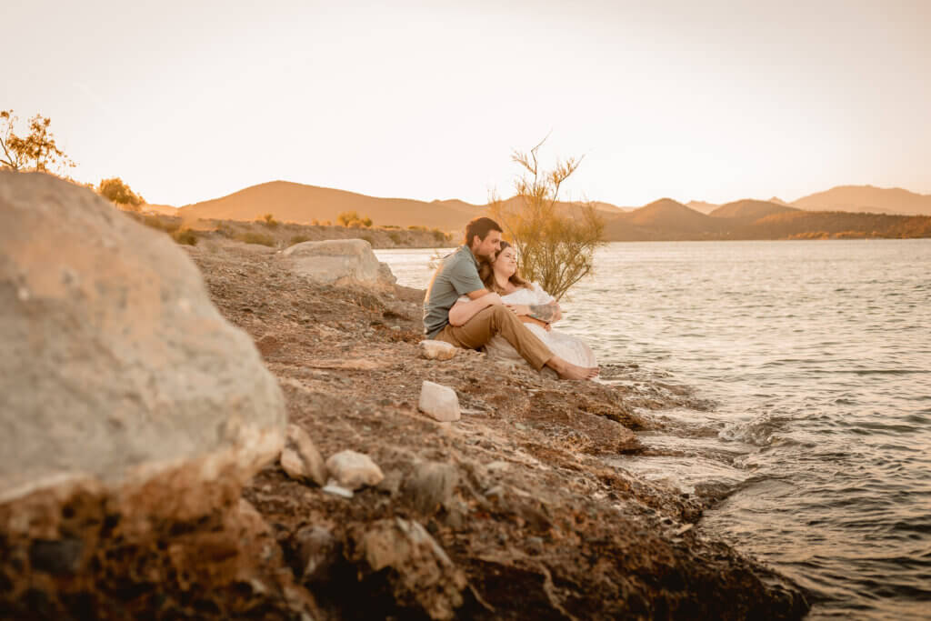 photo of engaged couple looking at the water at Lake Pleasant in AZ