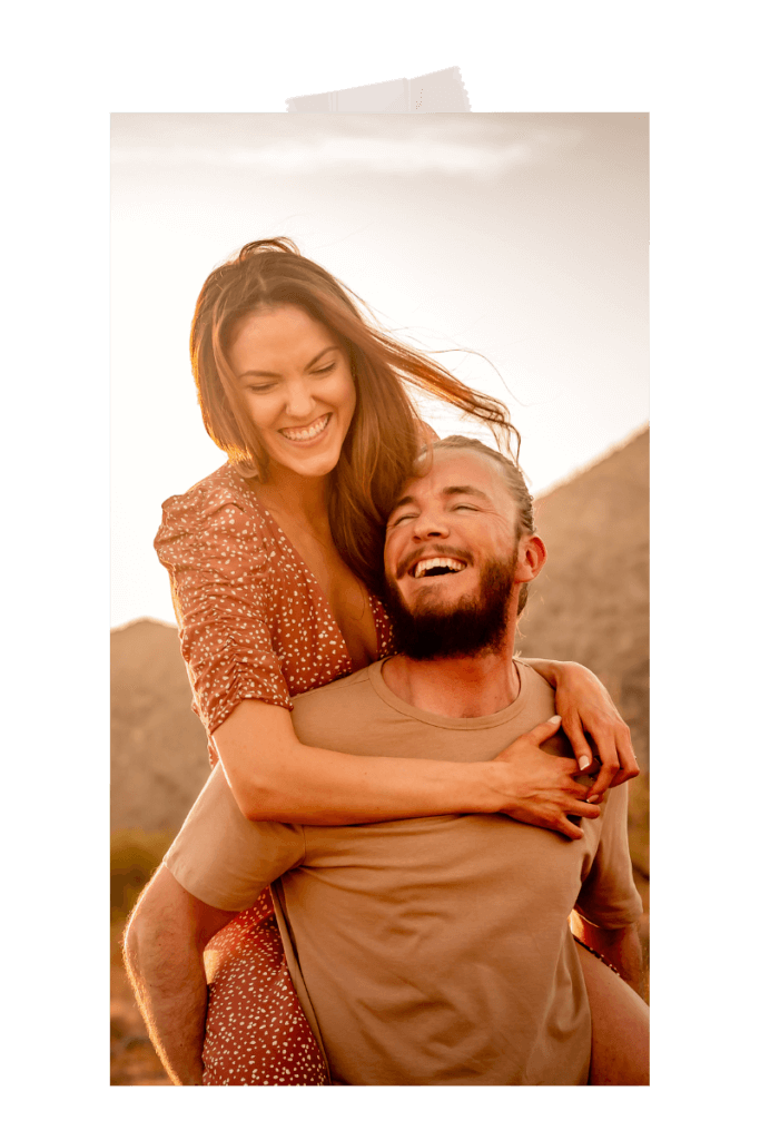 Photo of engaged couple goofing around on guy's back at the White Tank Mountains in the desert by photographer Memories by Candace