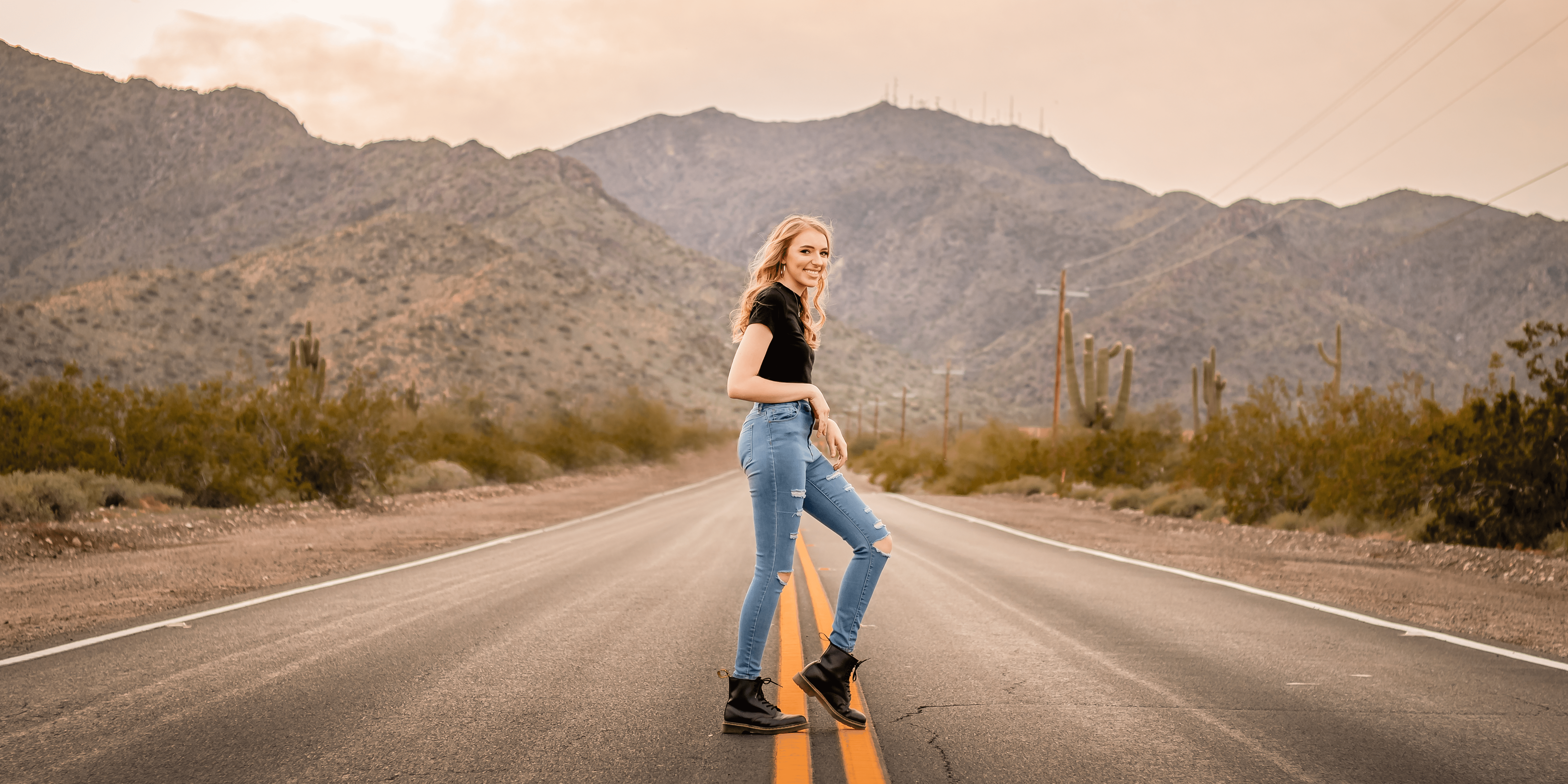 Senior photo of girl in the road at the base of the White Tank Mountains in the west valley by senior photographer Memories by Candace