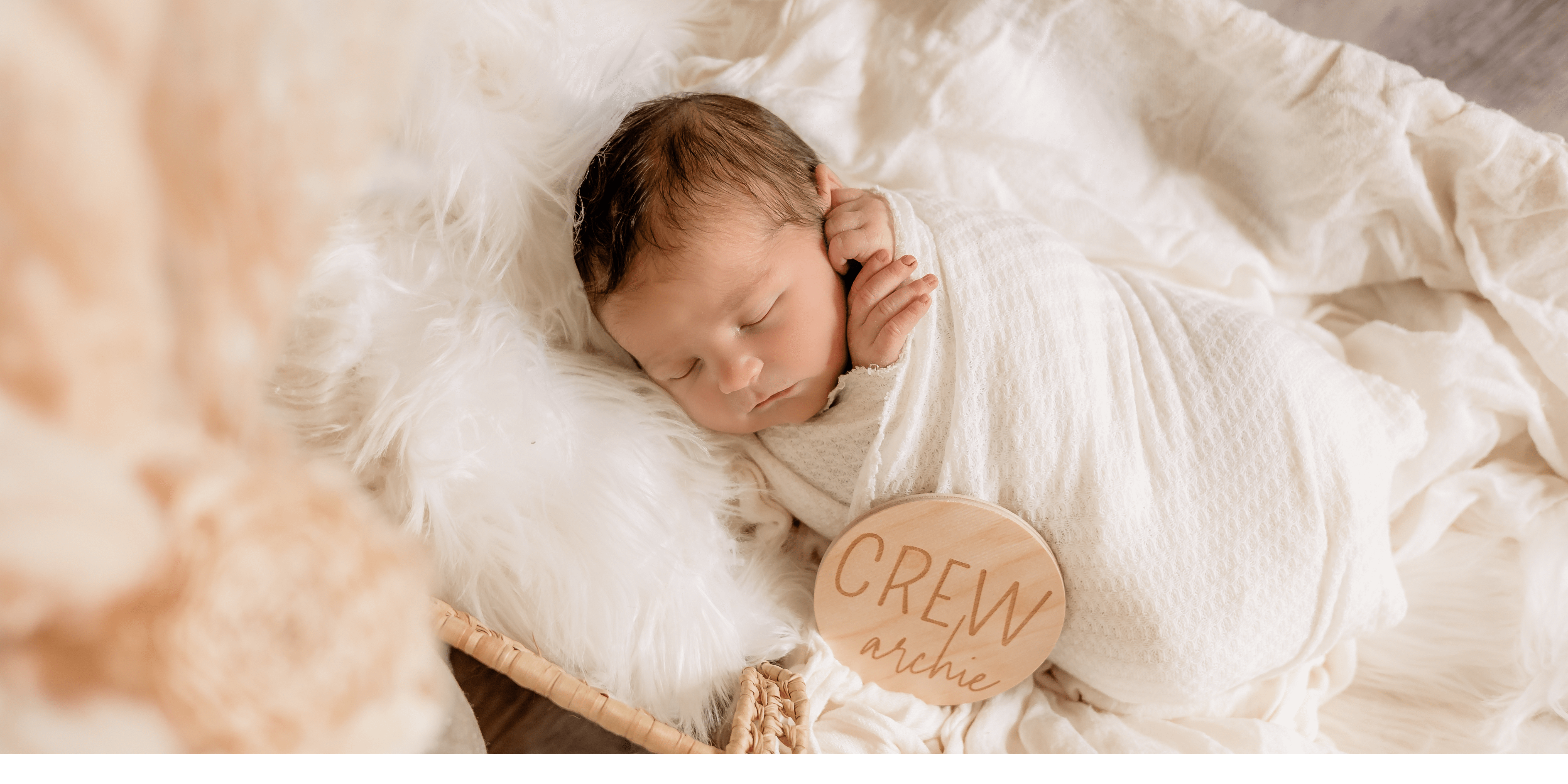 Newborn photo of baby lying in basket with name plate by newborn photographer Memories by Candace in Surprise, AZ