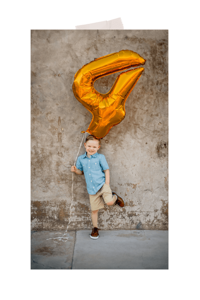 Photo of kid holding the number 4 balloon for his birthday in Scorpion Gulch Phoenix by photographer Memories by Candace