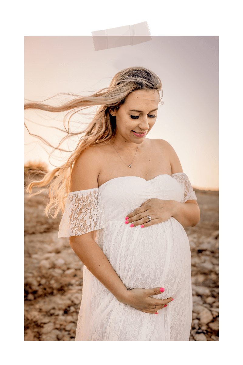 Maternity photo with the wind blowing through her hair at Lake Pleasant in Peoria, AZ by maternity photographer Memories by Candace