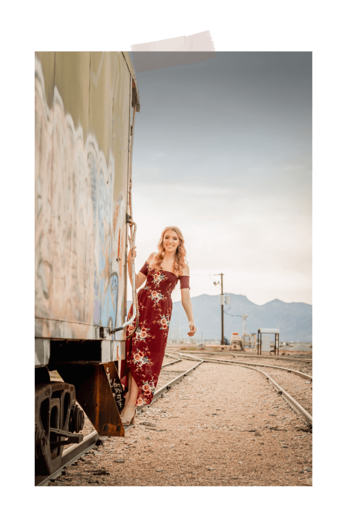 Senior photo with girl hanging off train in the Arizona desert near Phoenix by photographer Memories by Candace