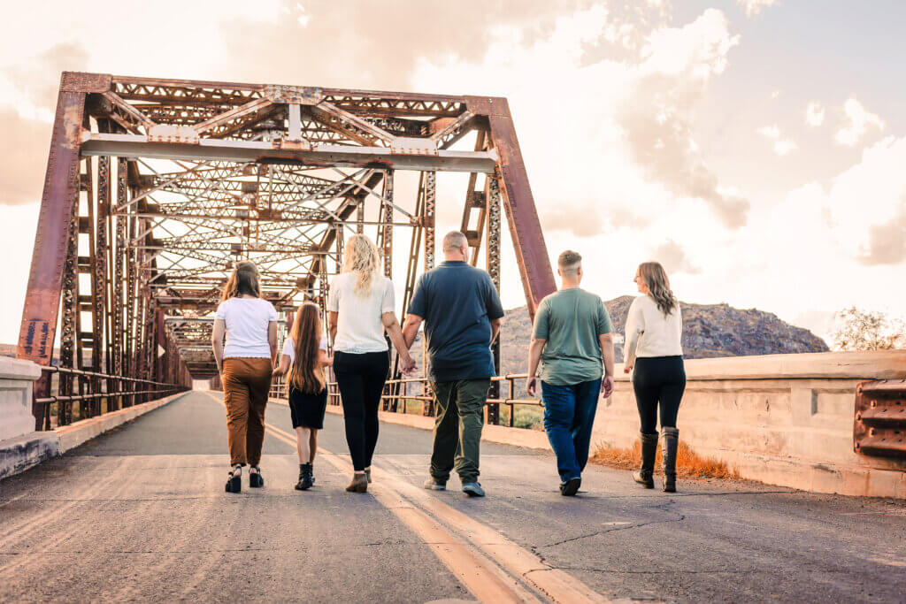 family walk through Gillespie Dam Bridge