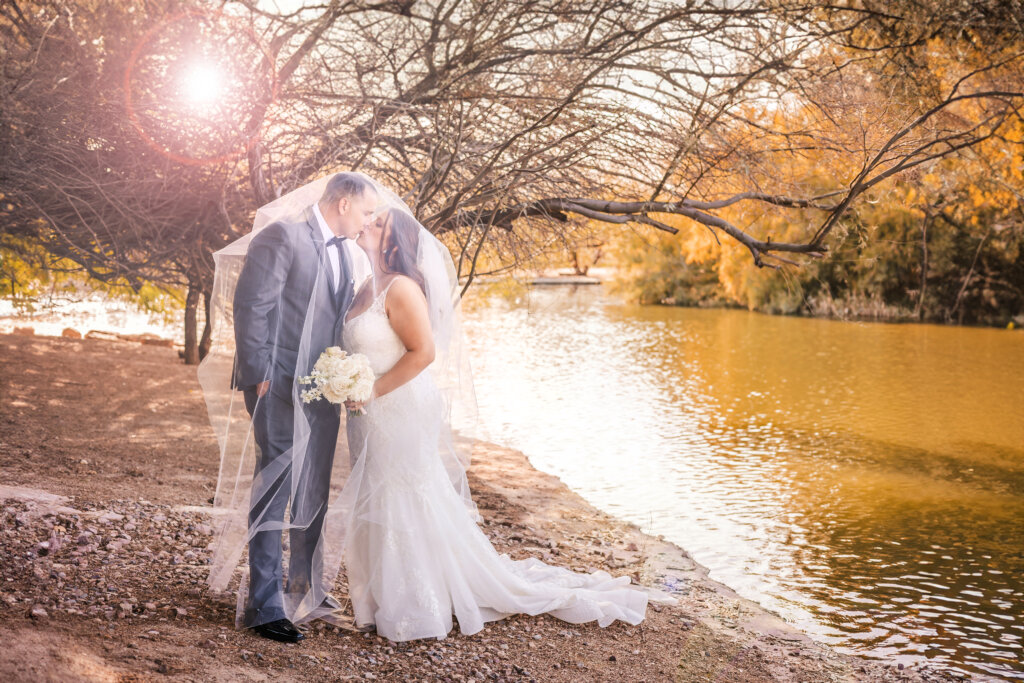 Wedding Photo of bride and groom kissing near Lake House of the Windmill Winery in Florence, AZ