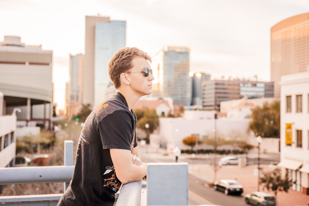 Toby looking out to the Downtown Phoenix City Skyline during senior portrait photo session