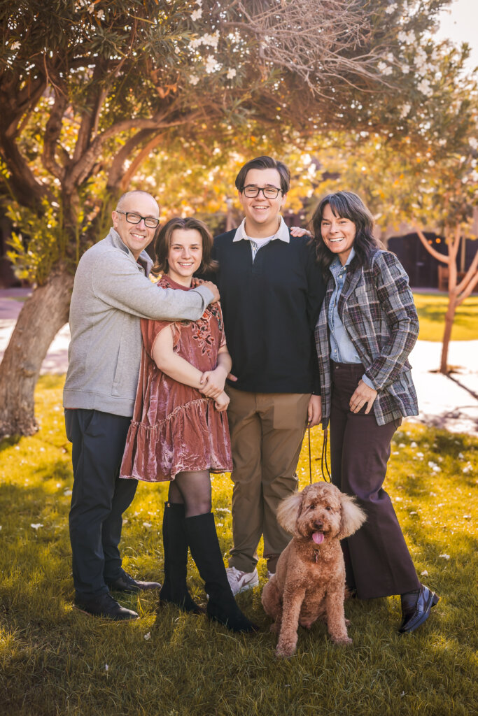 Phoenix-Family-Photographer-5 Photo of Family at Heritage Square Park in Downtown Phoenix with their dog under a green tree.