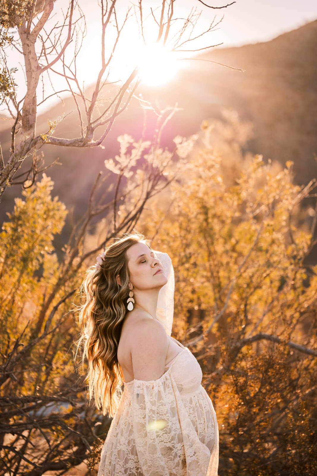 Golden hour expecting mother during maternity photo shoot.