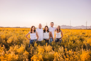 Family standing in broccoli fields for family photoshoot in Buckeye, Arizona. Captured by Phoenix family photographer.