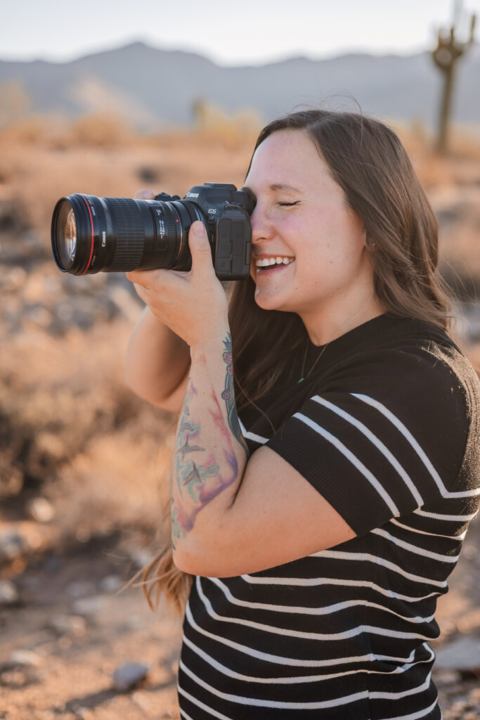 Shawna Wolf, associate photographer for Memories by Candace, holds camera up to her face preparing to capture the photo.