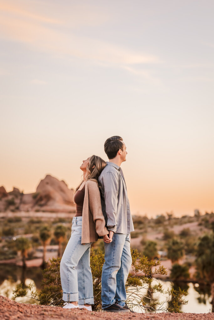 Adventurous desert engagement photo with jeans outfit and Phoenix mountain views