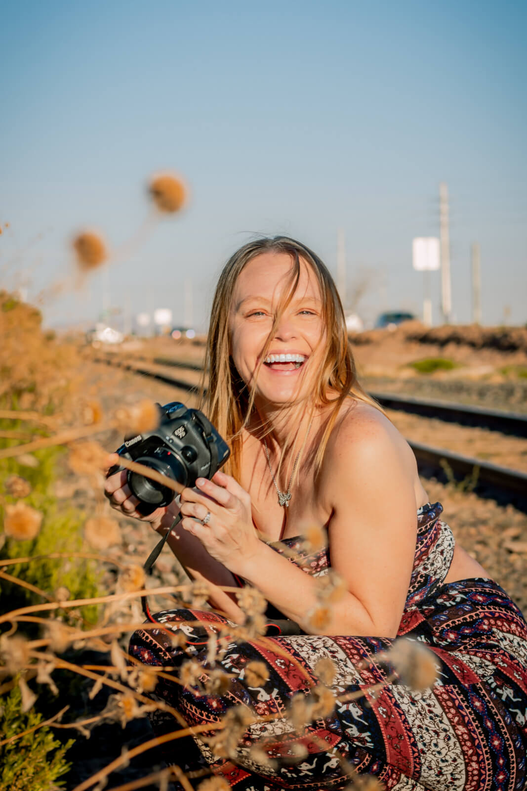 Photo of Candace Weir holding a camera, Photographer and owner of Memories by Candace, specializes in family, maternity, newborn, wedding, senior, and engagement photos in Phoenix.